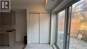 Kitchener townhouse for rent - A room with a sliding door and a window overlooking a construction site.