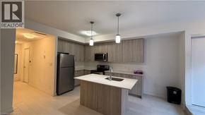 Kitchener townhouse for rent - A modern kitchen with a refrigerator, sink, and cabinets.