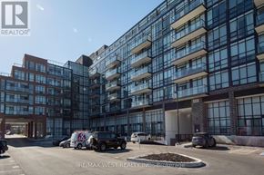 Barrie (Painswick South) condo for rent - A modern multi-story building with a parking lot in front.