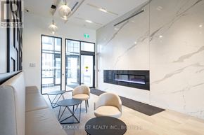 Barrie (Painswick South) condo for rent - A modern living room with a fireplace and a large window.