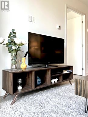 Toronto (Downsview-Roding-Cfb) condo for rent - A modern TV stand with a flat screen TV on top of it.