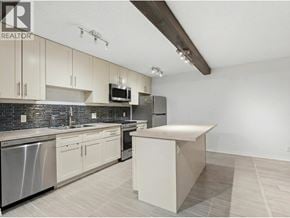 North Vancouver apartment for rent - A kitchen with a white countertop and stainless steel appliances.