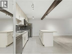 North Vancouver apartment for rent - A well-lit kitchen with white cabinets and a large island.