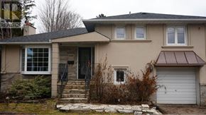 Toronto (Newtonbrook East) apartment for rent - A house with a brown roof and a white garage door.