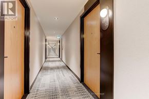 Vaughan (Beverley Glen) condo for rent - A long hallway with doors on either side and a light on the wall.