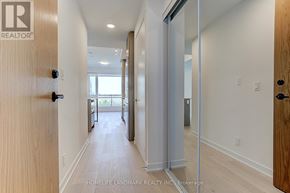Vaughan (Beverley Glen) condo for rent - A hallway with a glass door leading to a balcony.