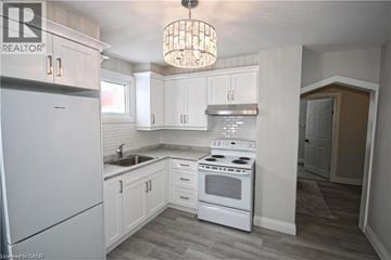 Hamilton apartment for rent - A kitchen with white appliances and cabinets.