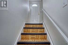 Pickering (Village East) apartment for rent - A set of stairs leading to a white door.