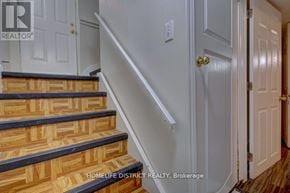 Pickering (Village East) apartment for rent - A staircase with wooden steps and a white wall.