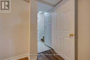 Pickering (Village East) apartment for rent - A white door with a gold handle is in a hallway.