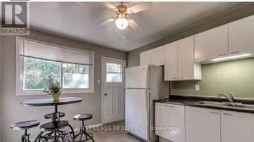 London East (East C) apartment for rent - A kitchen with white cabinets and a bar stool.