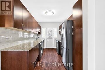 Toronto (Leaside) apartment for rent - A kitchen with brown cabinets and a marble countertop.