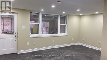 Kitchener apartment for rent - A room with a door, window, and a wall with switches.