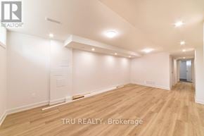 Ottawa apartment for rent - A room with wooden flooring and white walls, with a TRU REALTY logo on the top left corner.