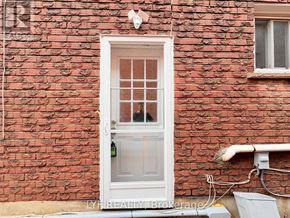Markham (Middlefield) apartment for rent - A white door with a window is on a red brick wall.