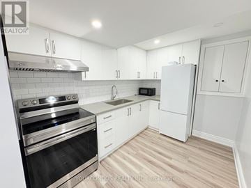 Markham (Middlefield) apartment for rent - A kitchen with white cabinets and a stainless steel oven.