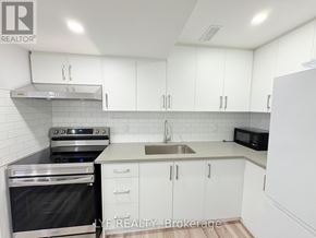 Markham (Middlefield) apartment for rent - A kitchen with white cabinets and stainless steel appliances.