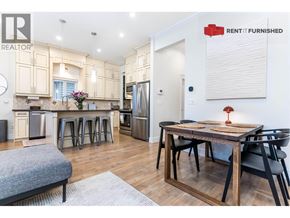 Vancouver apartment for rent - A kitchen with a table and chairs in the middle of the room.