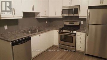 Toronto (Dovercourt-Wallace Emerson-Junction) apartment for rent - A kitchen with white cabinets and stainless steel appliances.