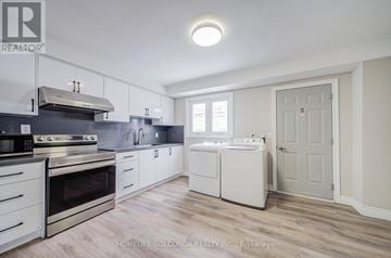 Toronto (Kensington-Chinatown) apartment for rent - A kitchen with white cabinets and appliances.
