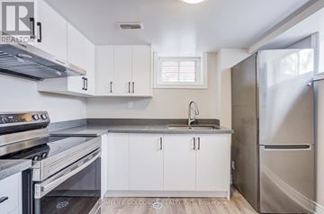 Toronto (Kensington-Chinatown) apartment for rent - A kitchen with white cabinets and stainless steel appliances.