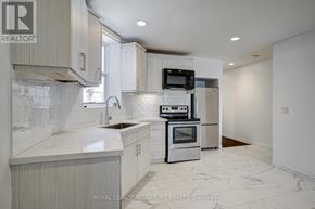 Toronto (Little Portugal) townhouse for rent - A kitchen with a sink, stove, and refrigerator.