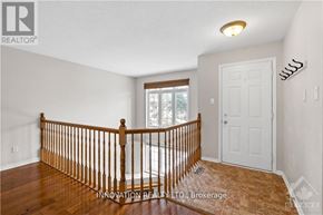 Ottawa townhouse for rent - A room with a wooden railing and a white door.