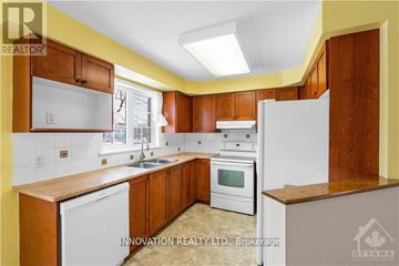 Ottawa townhouse for rent - A kitchen with wooden cabinets and white appliances.