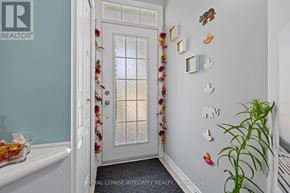 Ottawa townhouse for rent - A white door with a glass window and a wall with decorations.