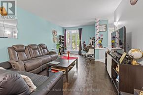 Ottawa townhouse for rent - A living room with a brown leather couch and a wooden coffee table.