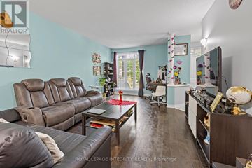 Ottawa townhouse for rent - A living room with a brown leather couch and a wooden coffee table.