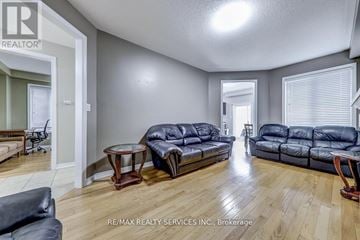 Innisfil (Alcona) apartment for rent - A living room with a black leather couch and a wooden floor.