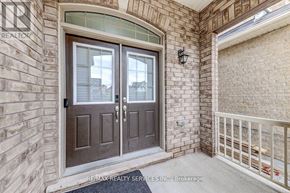 Innisfil (Alcona) apartment for rent - A brown double door with a glass window is the main focus of the image.