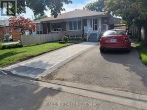 Richmond Hill (Crosby) apartment for rent - A red car is parked in front of a house with a sign that says "REAL ONE REALTY INC Brokerage.".