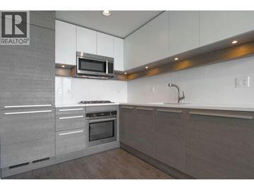 Burnaby apartment for rent - A modern kitchen with a microwave above the stove.