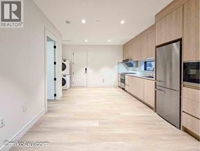 Vancouver apartment for rent - A kitchen with wooden cabinets and stainless steel appliances.