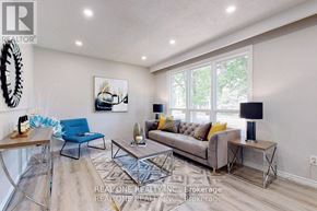Aurora (Aurora Heights) apartment for rent - A living room with a grey couch, a blue chair, and a wooden table.