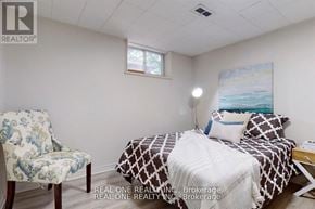Aurora (Aurora Heights) apartment for rent - A bedroom with a bed, chair, and painting on the wall.
