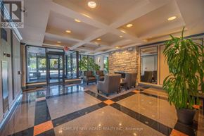Vaughan (Crestwood-Springfarm-Yorkhill) condo for rent - A lobby with a stone wall and a plant.