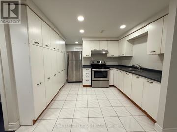 Mississauga (East Credit) apartment for rent - A white kitchen with a refrigerator, oven, and sink.