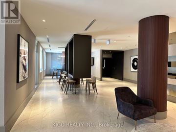 Kitchener condo for rent - A modern living room with a dark brown chair and a marble floor.