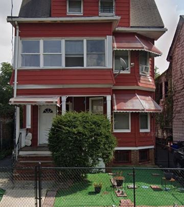 Newark apartment for rent - A red house with a white door and windows.