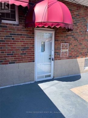 Toronto (Wexford-Maryvale) apartment for rent - A white door is under a red awning.