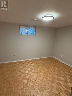 Toronto (Wexford-Maryvale) apartment for rent - A room with a wooden floor and a window.