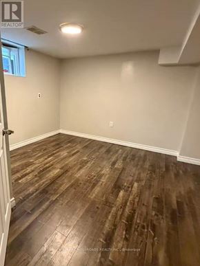 Toronto (Wexford-Maryvale) apartment for rent - A room with wooden flooring and white walls.
