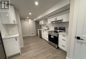 Barrie (Georgian Drive) apartment for rent - A modern kitchen with white cabinets and stainless steel appliances.