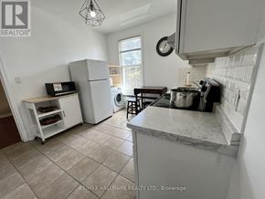 Toronto (Moss Park) duplex for rent - A kitchen with a marble countertop and a tile floor.