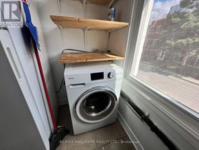 Toronto (Moss Park) duplex for rent - A small laundry room with a washer and dryer.