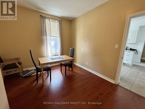 Toronto (Moss Park) duplex for rent - A room with a dining table and chairs in it.