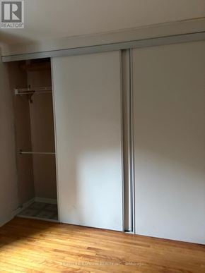 Toronto (Danforth) apartment for rent - A room with a sliding door and a wooden floor.
